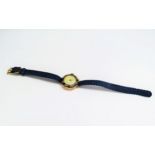A lady's gold watch having a dark blue enamel outer set with pairs of old cut diamonds, stamped 18k,