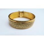 A Victorian gold double hinged bracelet, with black enamel decoration, Some wear to enamel, 5.6cm