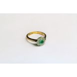 An emerald and diamond daisy ring, shank stamped 18ct/Plat. Size L, 2.8g