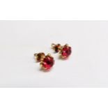 A pair of 14ct gold earrings with a red stone centre, 3.8g