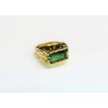 An 18ct gold ring set with a green tourmaline in textured mount. Size M/N, 10g