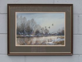 SYDNEY F. CLARKE (1939-2014) A framed and glazed watercolour, Mallards in flight over a Broads river
