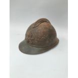 A WWI French Adrian helmet to the engineers with most of its original paint finish, no lining or