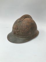 A WWI French Adrian helmet to the engineers with most of its original paint finish, no lining or