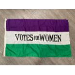 A reproduction 'VOTES FOR WOMEN' Suffragettes style flag