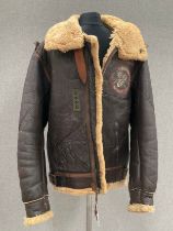 A WWII B3 sheepskin flying jacket by HLB Corp. New York, with artwork badge to front, size 46,