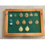 A board of Royal Marine Band helmet badges including Royal Yacht, Plymouth and Portsmouth divisions,