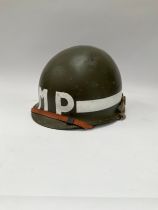 A post-war American helmet bearing MP (Military Police) lettering