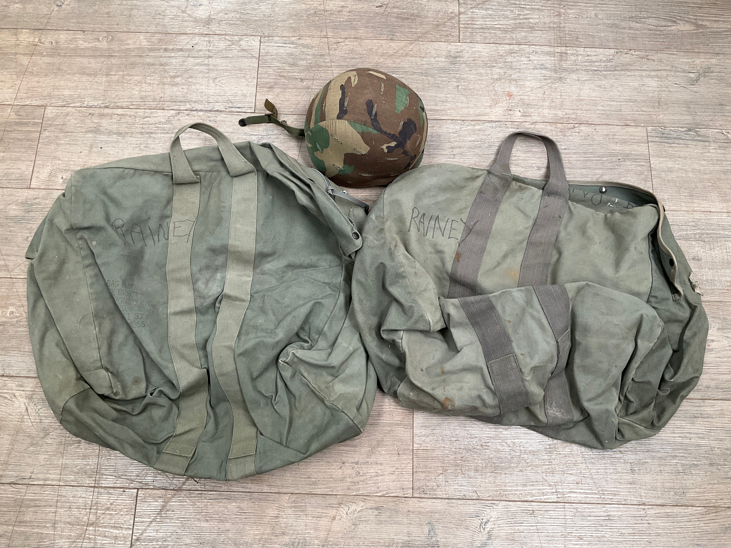 A post-war camouflage infantry helmet together with two holdalls (3)
