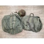 A post-war camouflage infantry helmet together with two holdalls (3)