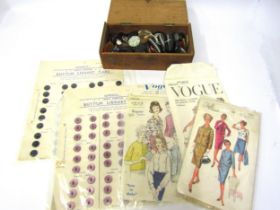 A wooden box containing vintage buttons, buttons on card and a small quantity of dressmaking