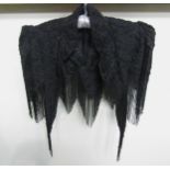 A Victorian black silk grosgrain elaborately beaded cape. The shoulders display exaggerated
