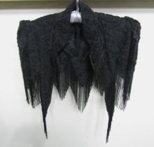 A Victorian black silk grosgrain elaborately beaded cape. The shoulders display exaggerated
