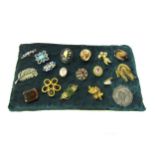 A cushion of 18 vintage brooches including jade and silver examples