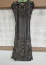 A 1920's black lace evening dress embellished with silvered embroidery and beading. The dress has