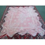 A Victorian peach bedcover with a cream lace worked overlay