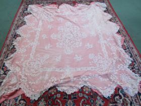 A Victorian peach bedcover with a cream lace worked overlay