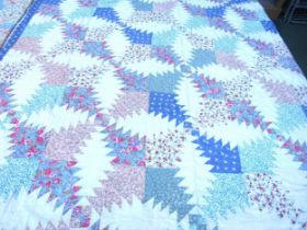 A hand stitched American style patchwork cotton throw