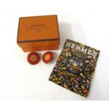 A pair of Hermes clip-on earrings in original box together with a Hermes notebook