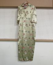 A Chinese silk full length dress, gold ground with floral sprays and Chinese motifs