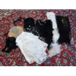 A box containing assorted fashion accessories to include two silk shawls in cream and black with