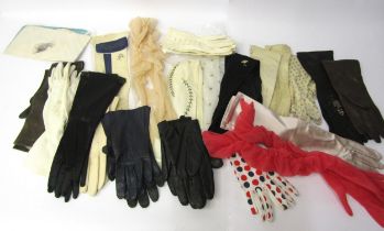 A box containing vintage fashion gloves in various colours, styles and fabrics, leather and suede