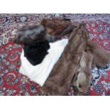 A box containing vintage furs including a mid brown fox fur stole, two fox fur evening capes, a