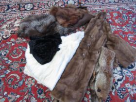 A box containing vintage furs including a mid brown fox fur stole, two fox fur evening capes, a