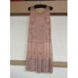 A 1920's pale peach chiffon beaded dress, the dress has a drop waistband and is decorated with