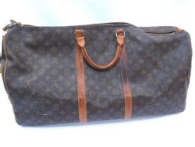 LOUIS VUITTON; Keepall 60 Boston travel bag. Brown monogram. The leather handles, banding and piping