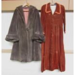 A 1940's/50's amber velvet house coat with pleated collar and cuff, covered button detail to front