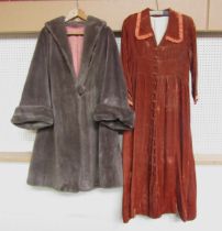 A 1940's/50's amber velvet house coat with pleated collar and cuff, covered button detail to front