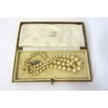 A two row faux pearl necklace with a marcasite clasp, boxed