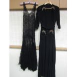 Two early 20th Century evening dresses, one black crepe with a jewelled bead design style at hip and