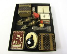 A box containing vintage perfume bottles including Chanel and Guerlain, Diamante Negro, trinket