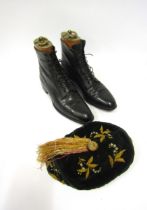 A pair of Victorian black leather lace-up ankle boots with twine leather laces together with a