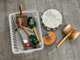 A box of mixed ethnic and percussion instruments