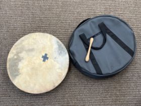 A bodhran with beater and case, tape to skin