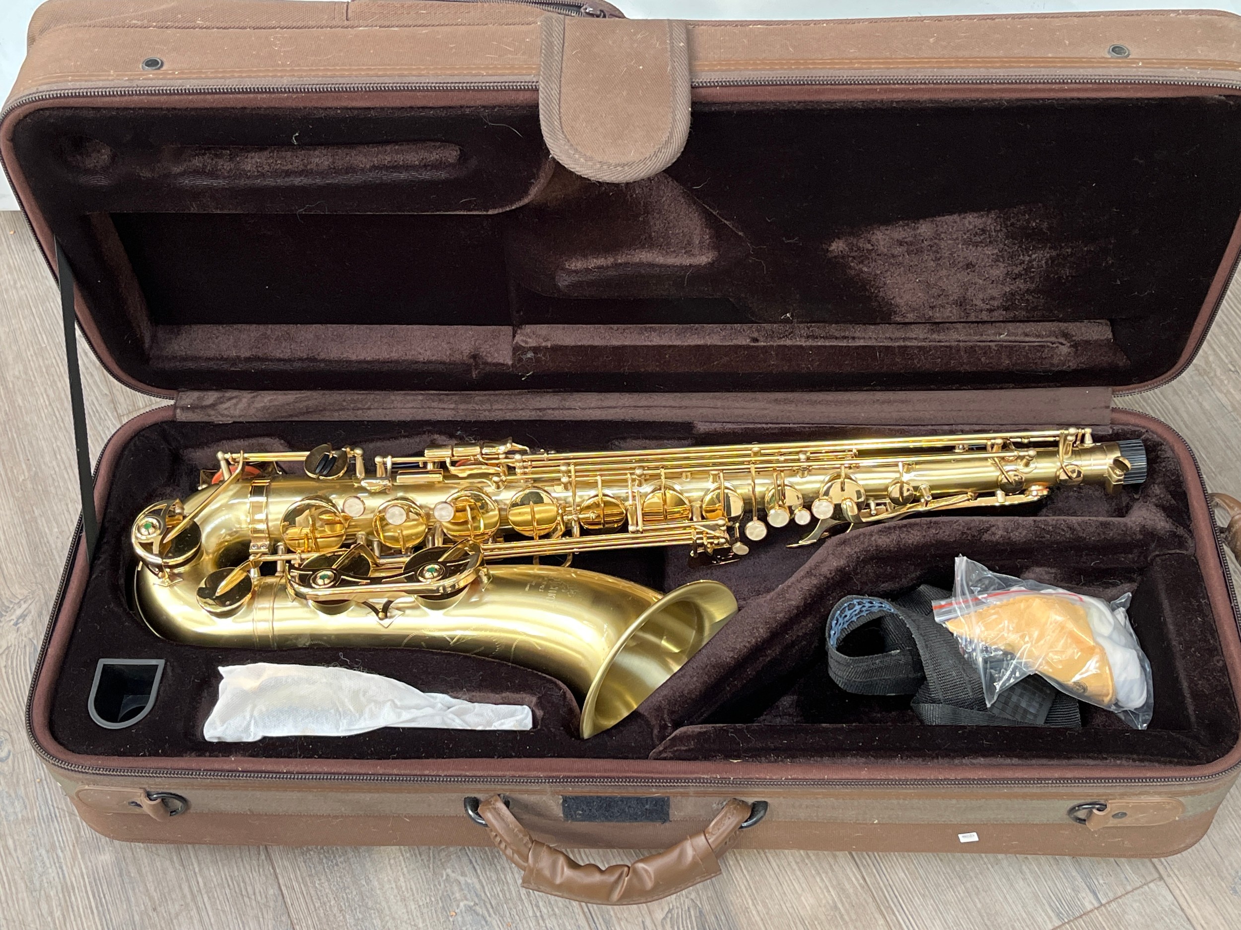 A Jericho tenor saxophone, brass, cased with accessories