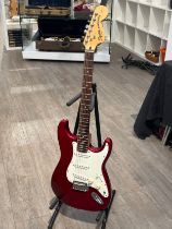 A Fender Squier strat in red, serial number ICO60625142