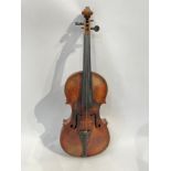 A late 19th / early 20th Century Guarneri copy violin, full size (4/4), two piece figured maple