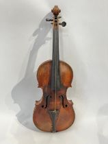 A late 19th / early 20th Century Guarneri copy violin, full size (4/4), two piece figured maple