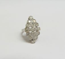 A platinum ring set with diamonds in milgrain honeycomb design, the centre with a row of diamonds.