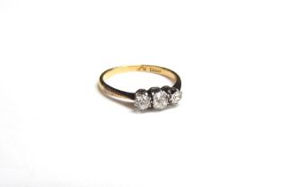 An 18ct gold platinum set three stone diamond ring, 0.40ct total approx. Size L, 2g