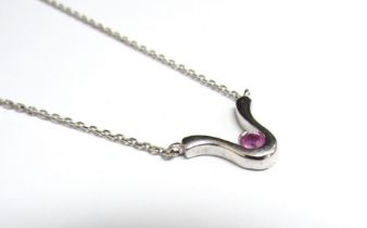 A 9ct white gold necklace hung with a pink sapphire set pendant, 42cm long, 3.3g