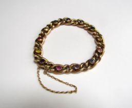 A gold bracelet each large link set with a semi-precious stone including citrine, amethyst, topaz