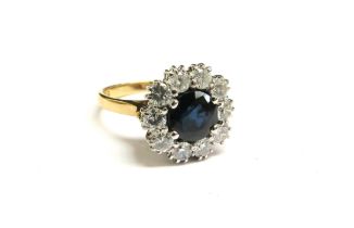 An 18ct gold sapphire and diamond cluster ring, 13mm diameter, 1ct total approx. Size M/N, 4.4g