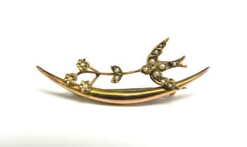A 9ct gold brooch with a seed pearl set bird and floral sprig, 1.8g