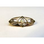 A Murrle Bennett & Co gold art nouveau style brooch set with an opal and peridots, stamped 15ct, 3.