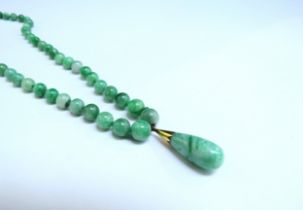 A graduated jade bead necklace hung with jade droplet with diamond and pearl set clasp, 55cm long,